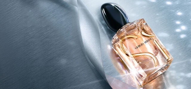 Giorgio Armani perfume bottle on a brushed metallic background.