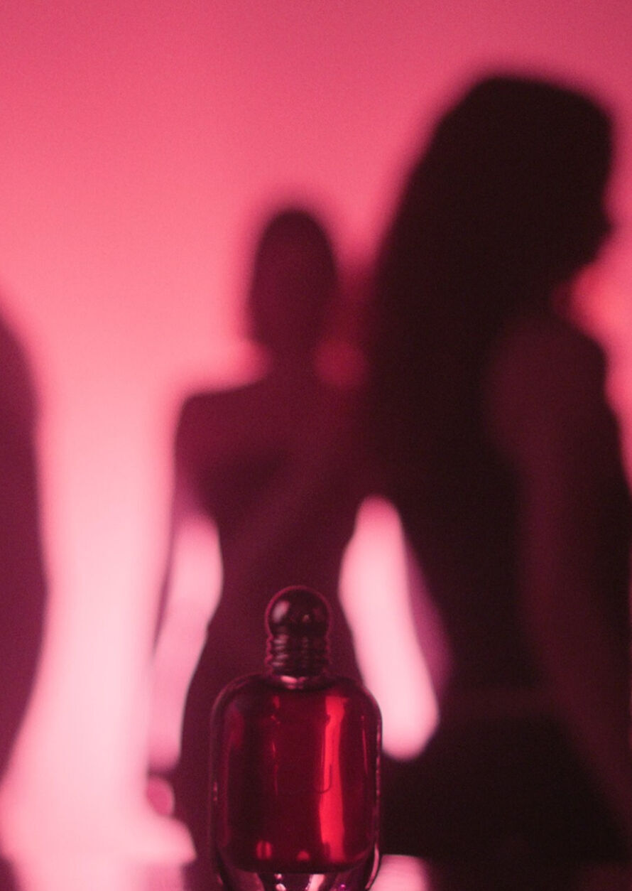 Shadows and ruby lights set the scene as Kendall Jenner walks in, surrounded by dancing silhouettes, before reaching for the Armani Power of You perfume bottle in a radiant packshot finale.