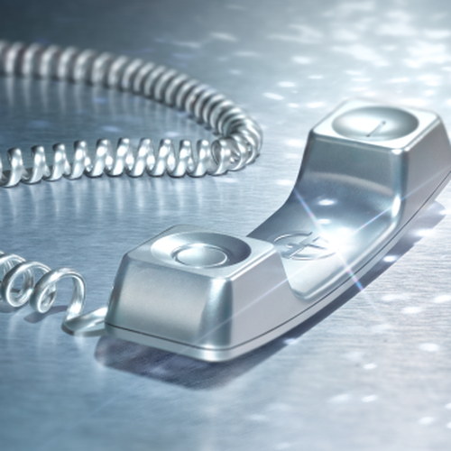 Silver phone receiver on metallic surface.