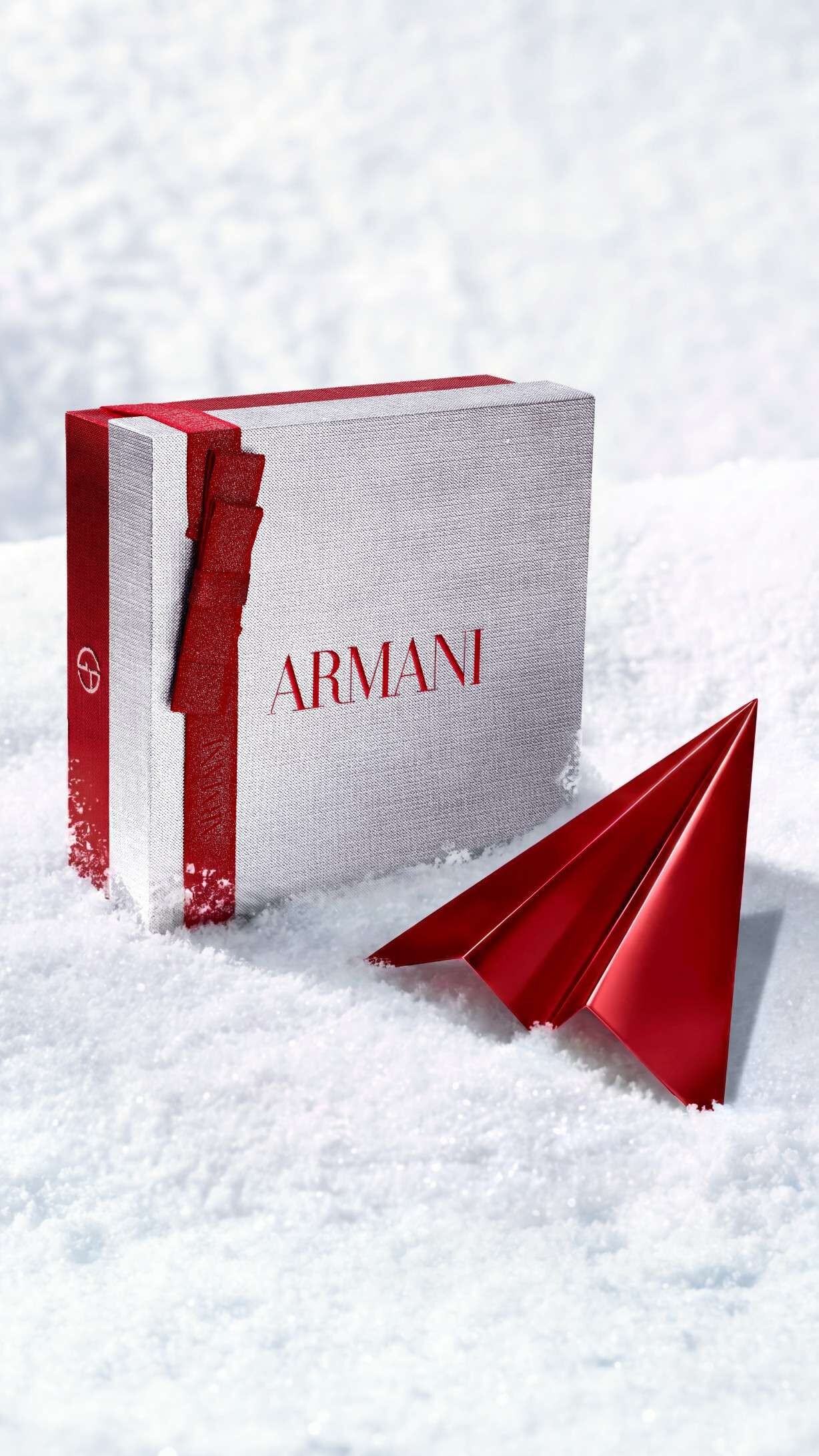 Armani beauty silver gift box with red paper plane for complimentary holiday delivery. 