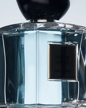 A video showcasing the Vetiver d'Hiver Armani / Prive fragrance, featuring close-ups of the perfume bottle, abstract textures evoking water and ice, and human silhouettes interacting with the bottle, concluding with the Armani / Prive logo.
