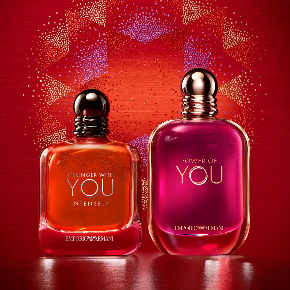 Two Emporio Armani fragrances, Stronger With You Intensely and Power of You, against a red festive background.​