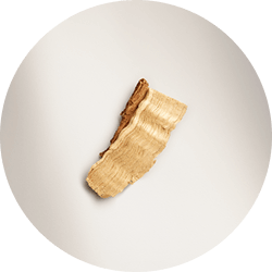 A single, elegant slice of green pear, is presented on a white background.
