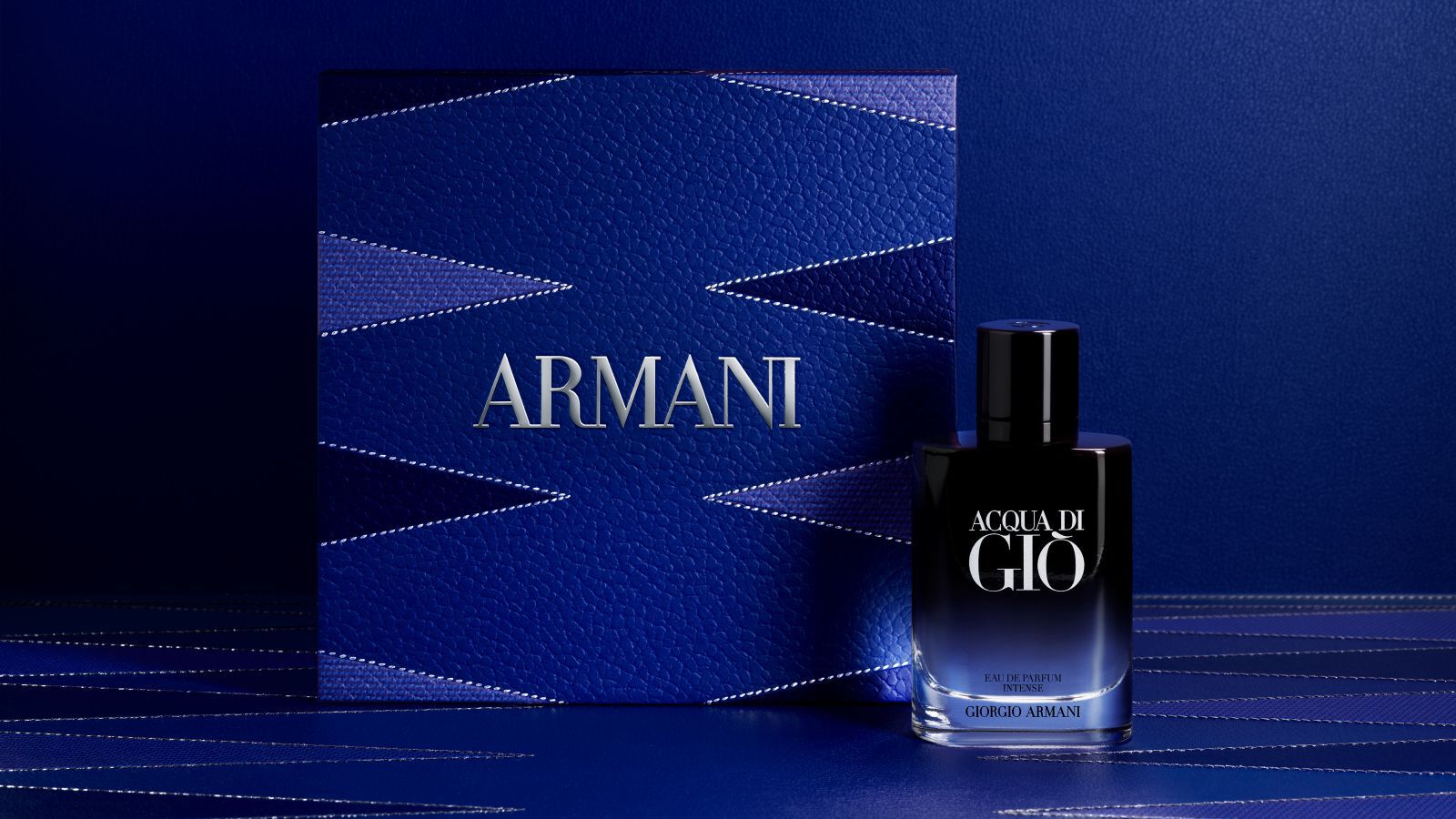 Giorgio Armani "Acqua di Gio" fragrance bottle with a textured blue Armani gift box.