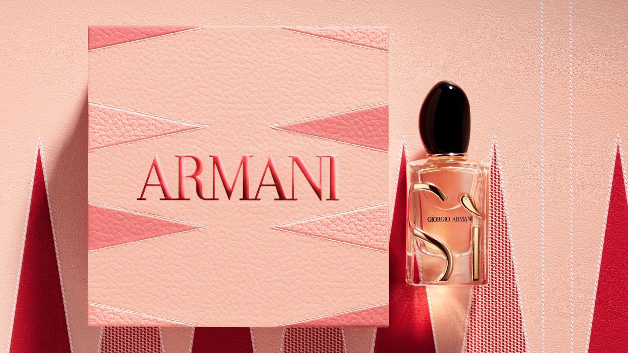 Giorgio Armani "Si" perfume bottle next to a large, textured pink Armani gift box.