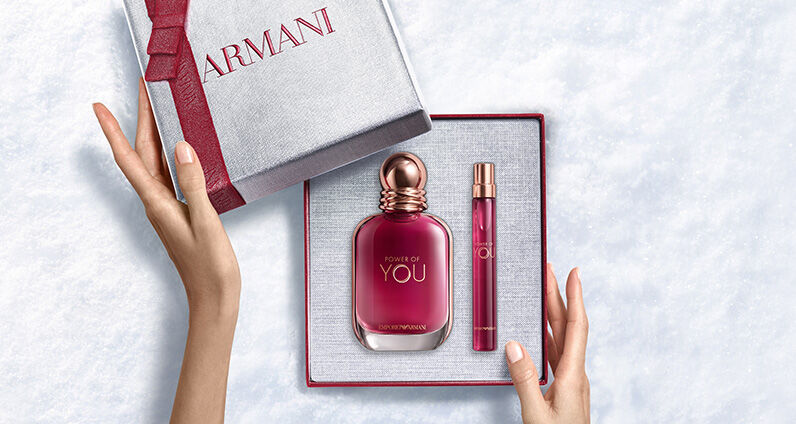 Giorgio Armani "Si" perfume bottle next to a large, textured pink Armani gift box.