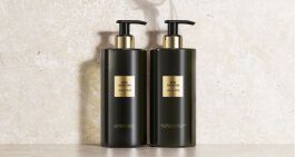 Two elegant bottles of body wash gracefully displayed on a polished table, exuding luxury and sophistication.