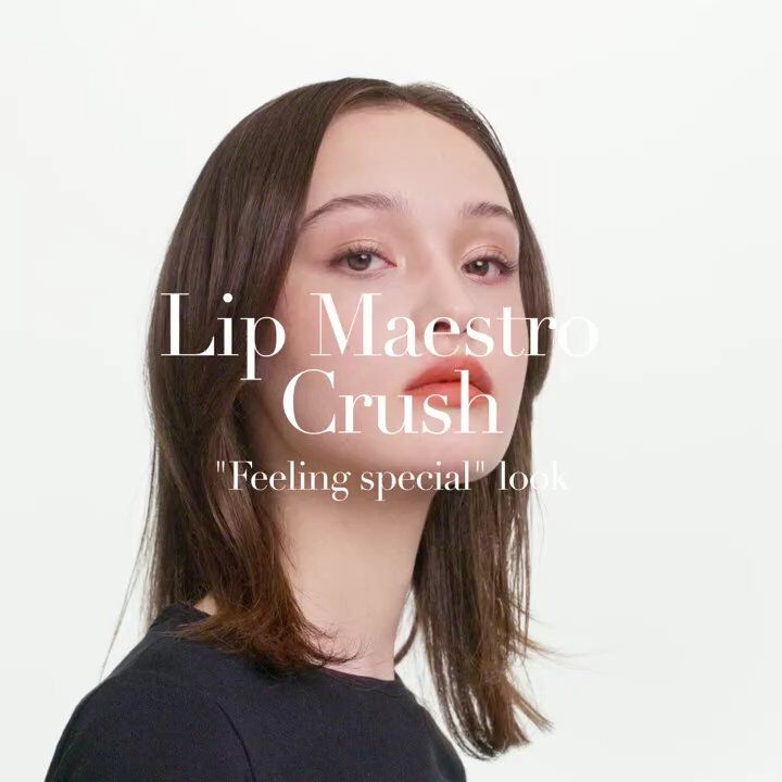 A young woman with medium-length hair showcases a soft makeup look featuring bold lips, with text overlay promoting 'Lip Maestro Crush.'